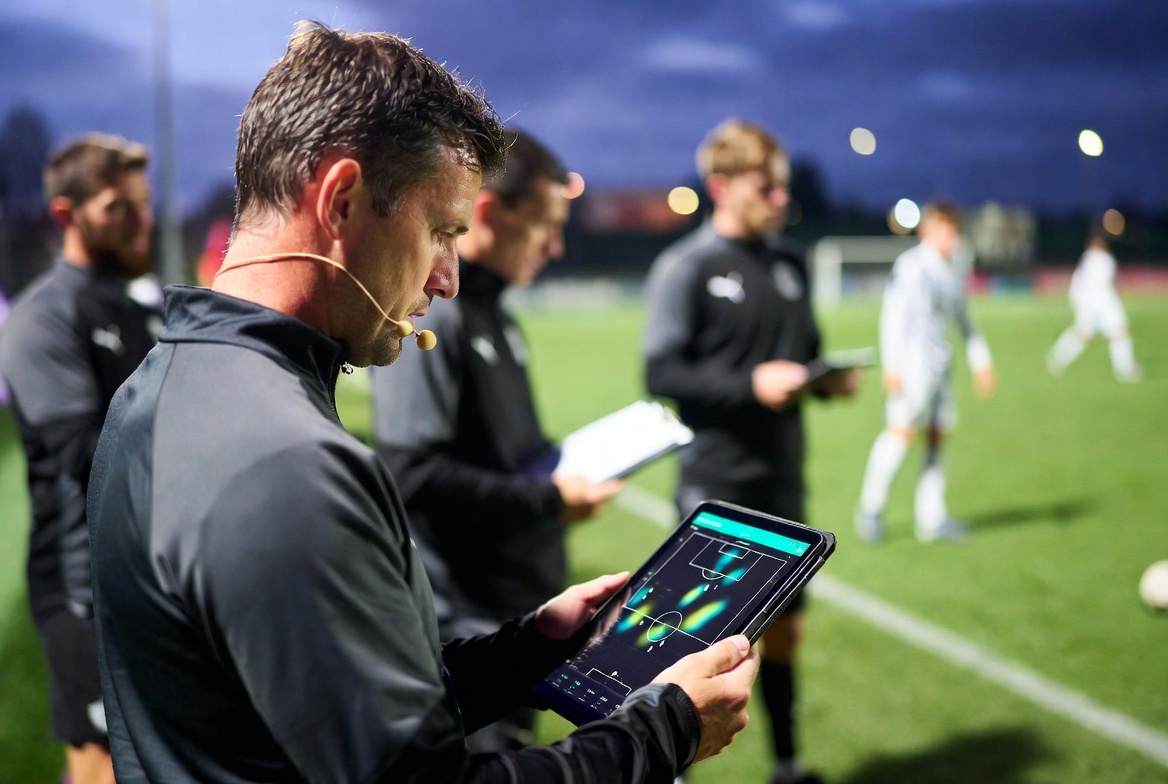 Coach reviewing pitch heat map analytics